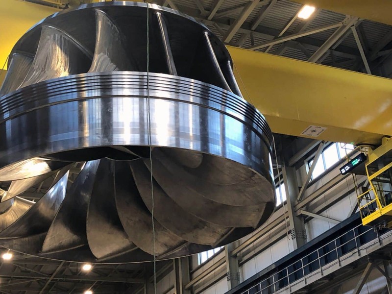 A large metal turbine hanging from a ceiling.