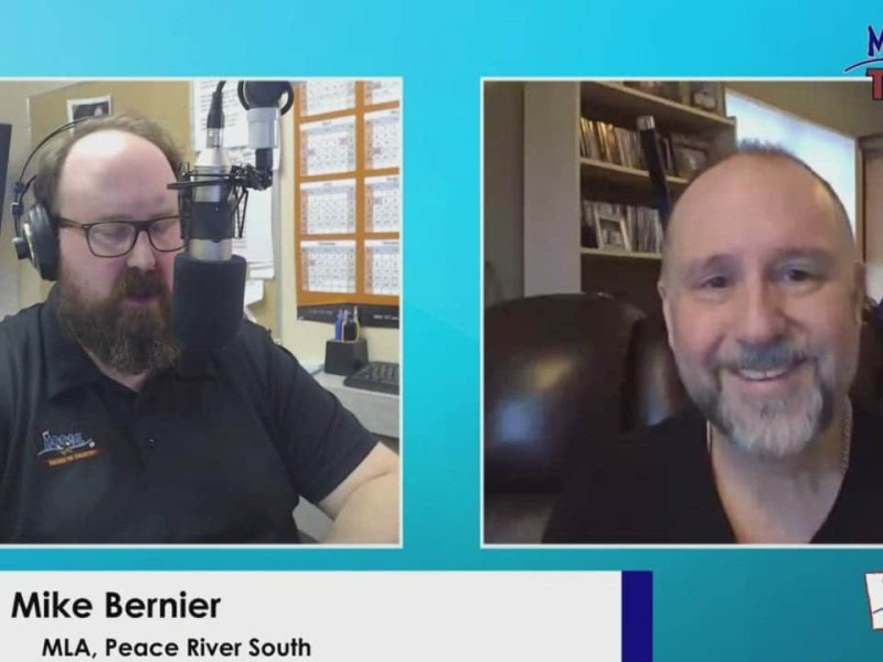 Two people on a video call. Man on left looking down