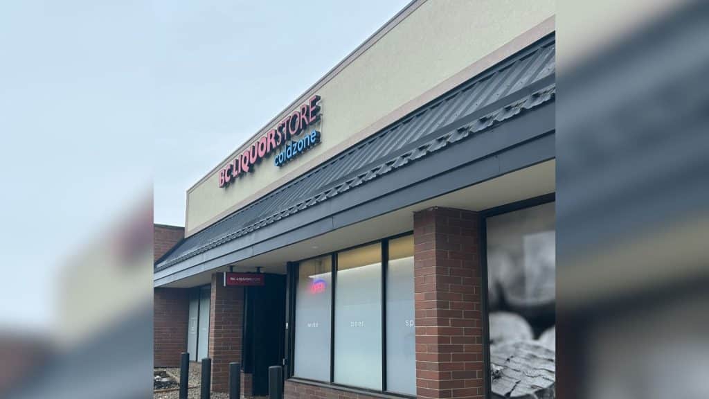 The front of the BC Liquor Store in Fort St. John. A brick building with an open sign in the window.