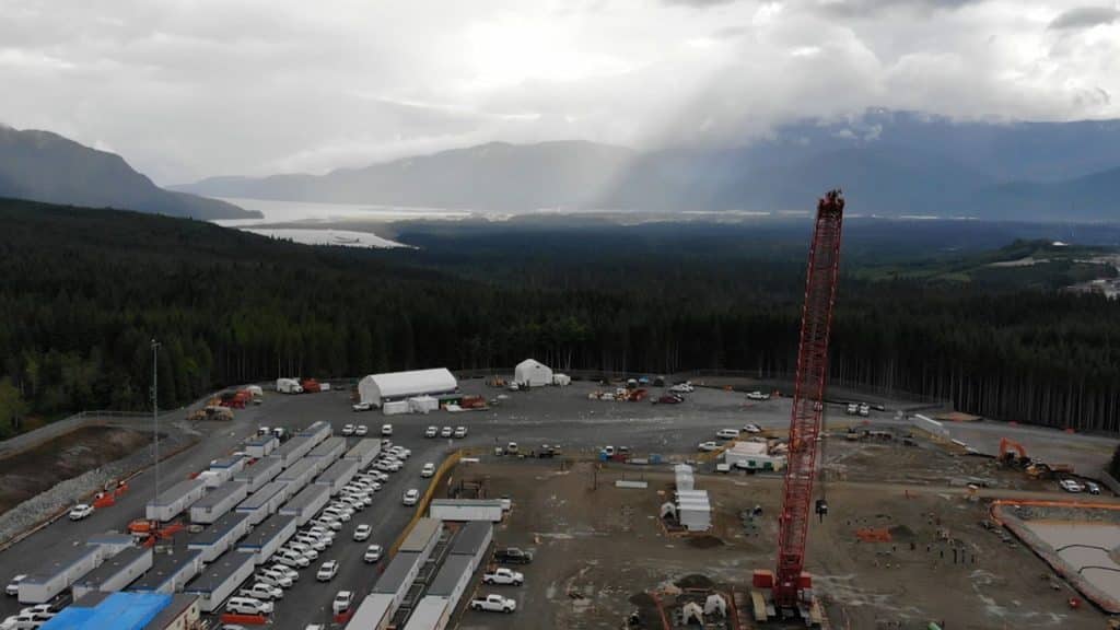 A large construction area surrounded by trees