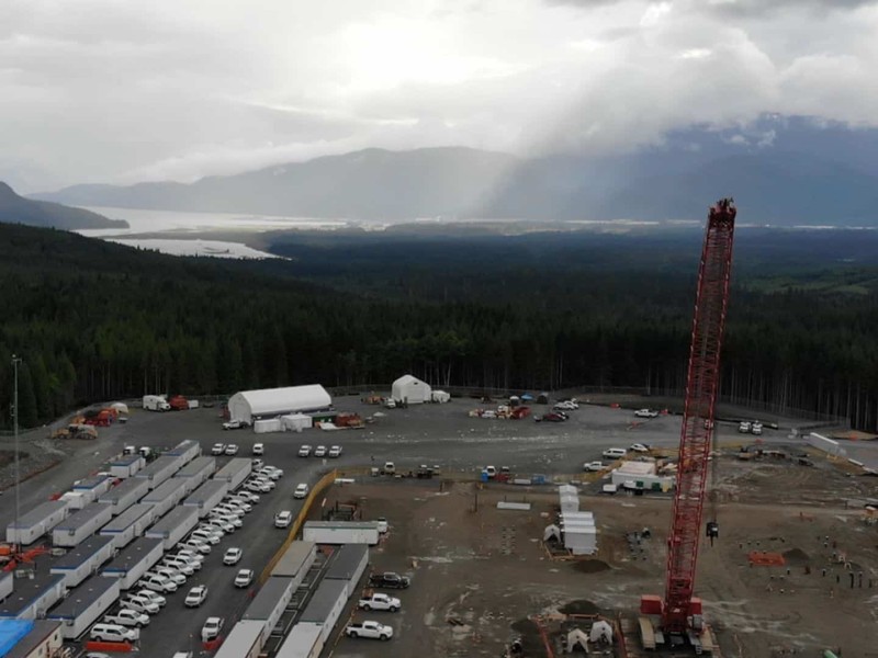 A large construction area surrounded by trees