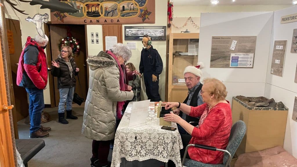 Volunteers Evelyn Sim and Larry Evans sell tickets to the Fort St. John North Peace Museum’s Christmas Tea on December 7