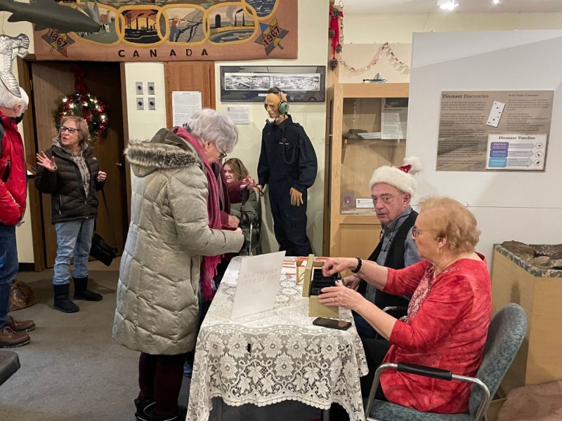 Volunteers Evelyn Sim and Larry Evans sell tickets to the Fort St. John North Peace Museum’s Christmas Tea on December 7