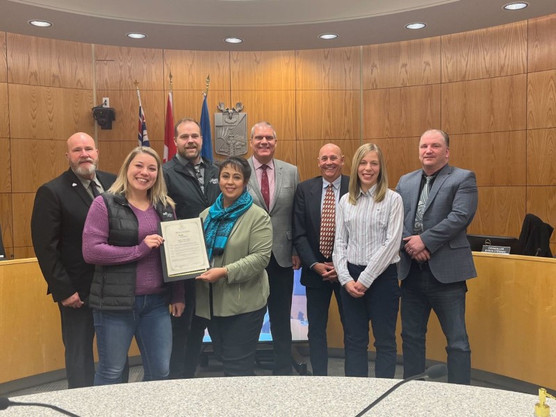 Jessica Kalman of the Fort St John Literacy Society collects the proclamation from Fort St. John City Council.