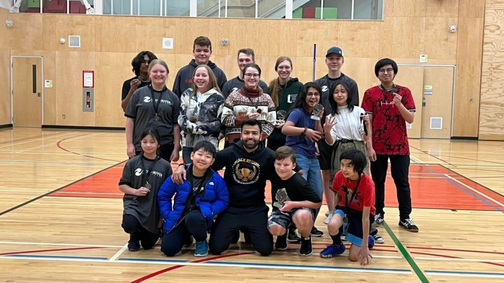 Peace Region Badminton & Recreational Club tournament winners and head coach. (Supplied)