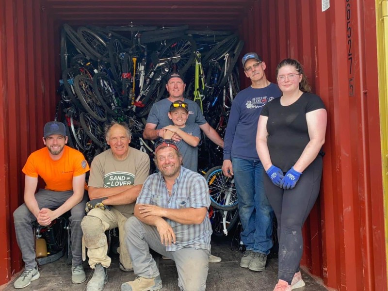 Members of the Edmonton Chapter of B4H in front of their last shipment of bicycles