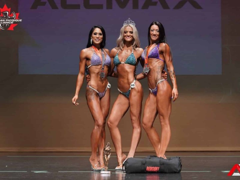 Dévre Gibson and two other competitors on stage. (Supplied-Taken by Ali Sohrab Photography)