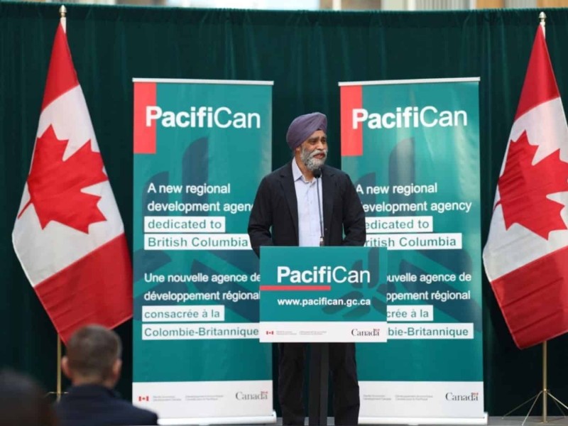 Harjit S. Sajjan in front of PacifiCan signage