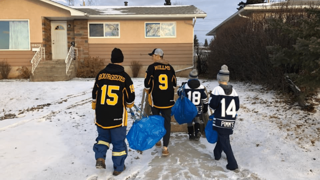 Huskies and minor hockey players going door to door to 'Fill the Bus' for the food bank.