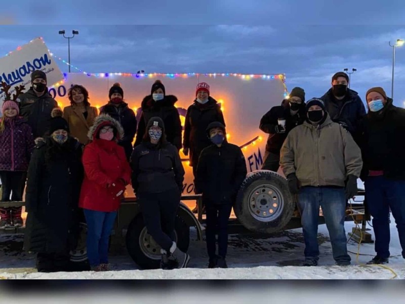 Moose FM staff in front of Light a Moose Sign (Adam Reaburn)