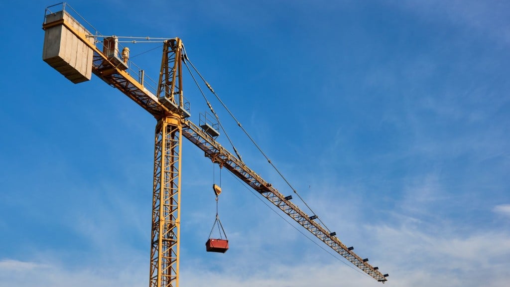 A crane up against a blue sky with some clouds.