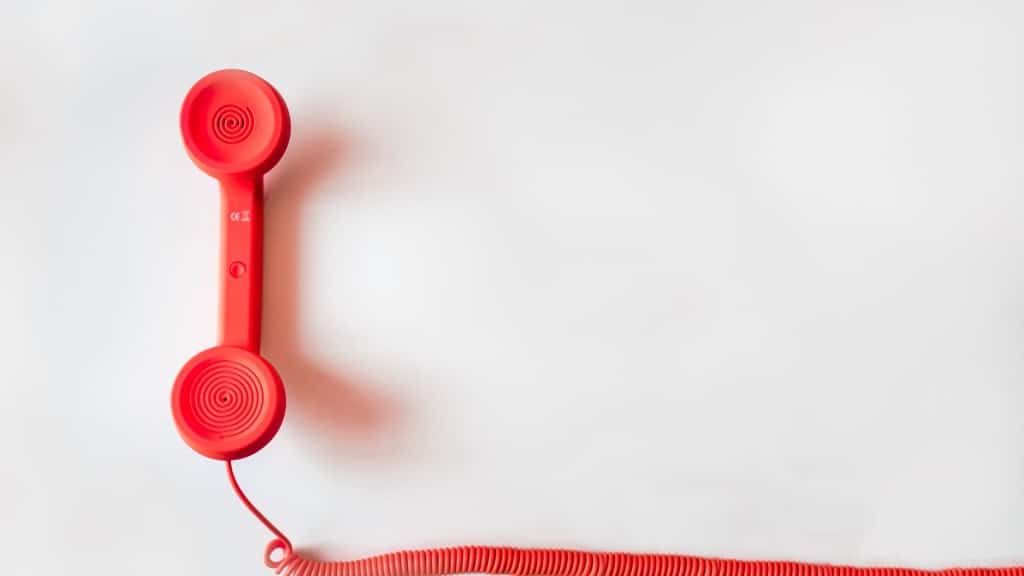 A red corded phone. (Canva)