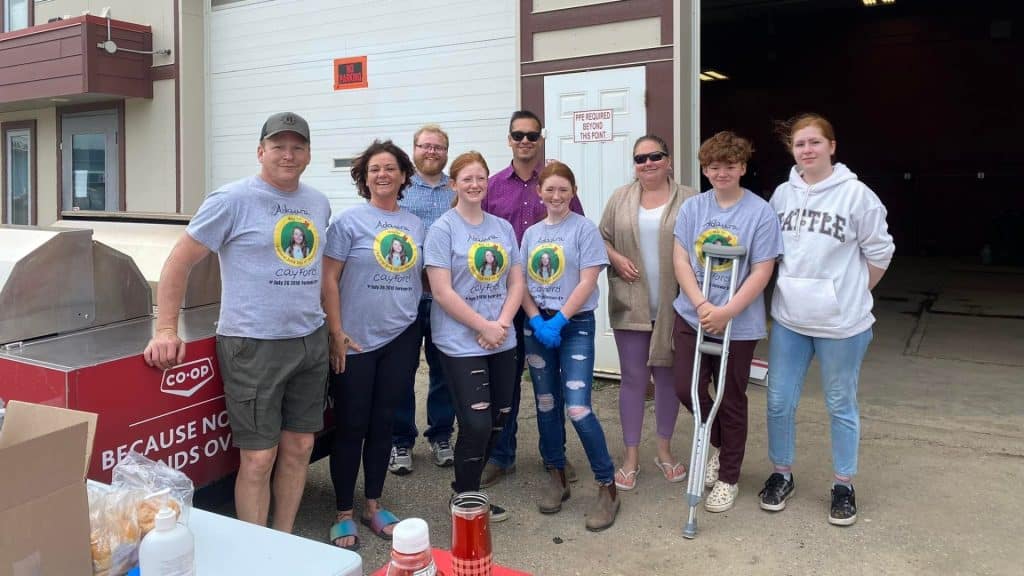 A family wearing matching t-shirts for the youngest of the family.