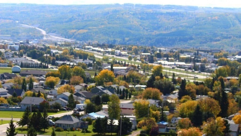 An aerial shot of a small town located in a valley.