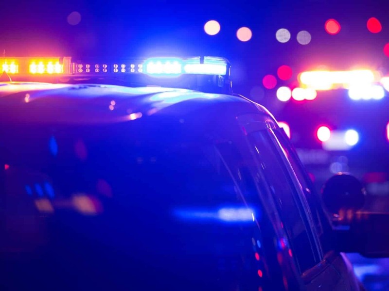 RCMP Car with lights flashing and more lights flashing in the background.