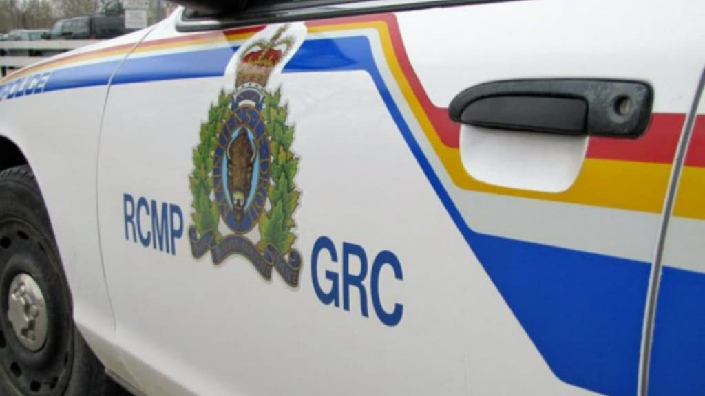 Side of a RCMP cruiser. A white car with an RCMP logo