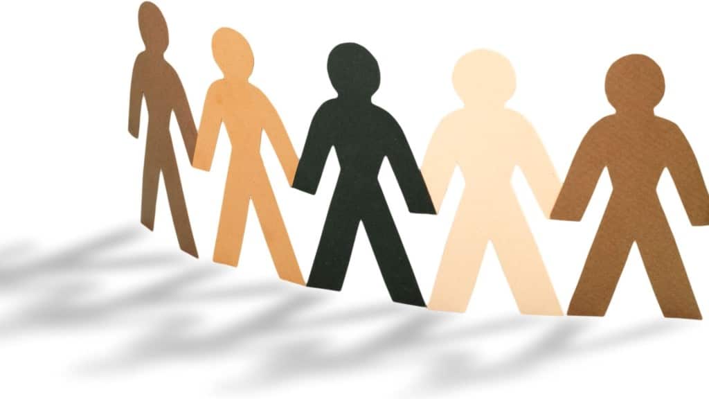 Paper dolls of different colours on a white background.