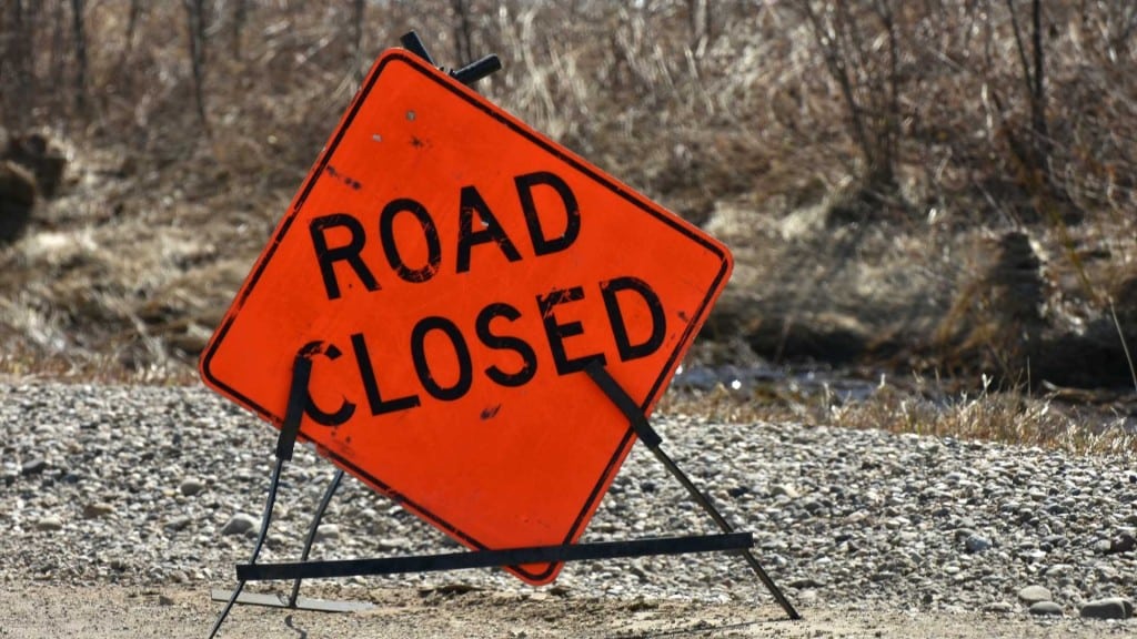 An orange road closed sign.