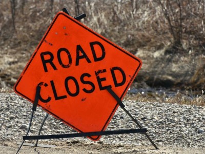An orange road closed sign.