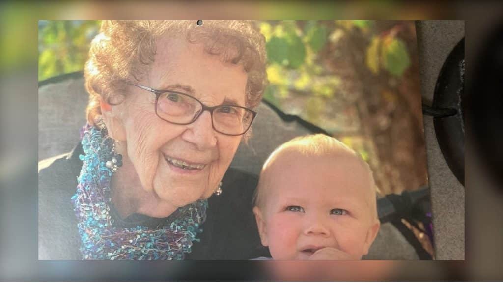 A photo of an old woman and her grandchild.