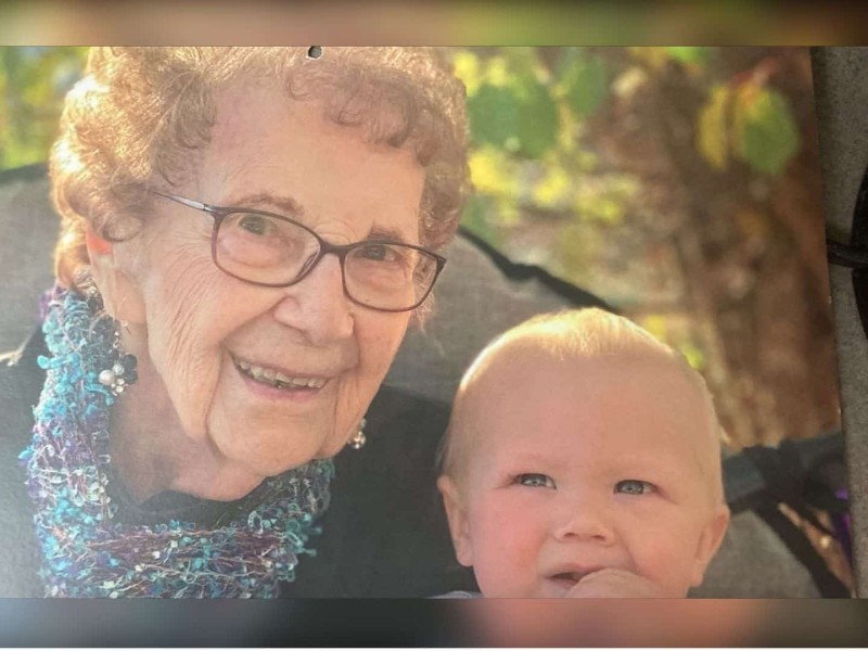 A photo of an old woman and her grandchild.