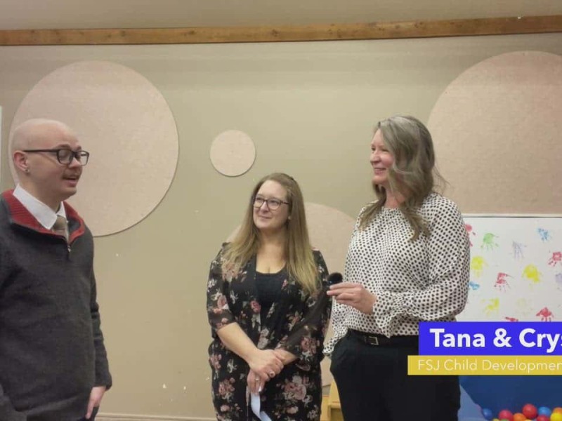 Person on left with glass in a sweater, person in middle with long hair, person on right with polka dot shirt