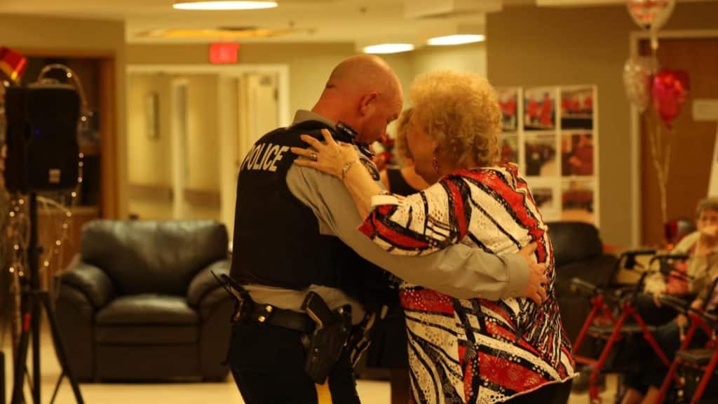 An RCMP officer dancing with a senior woman at a Valentine's Day dance.