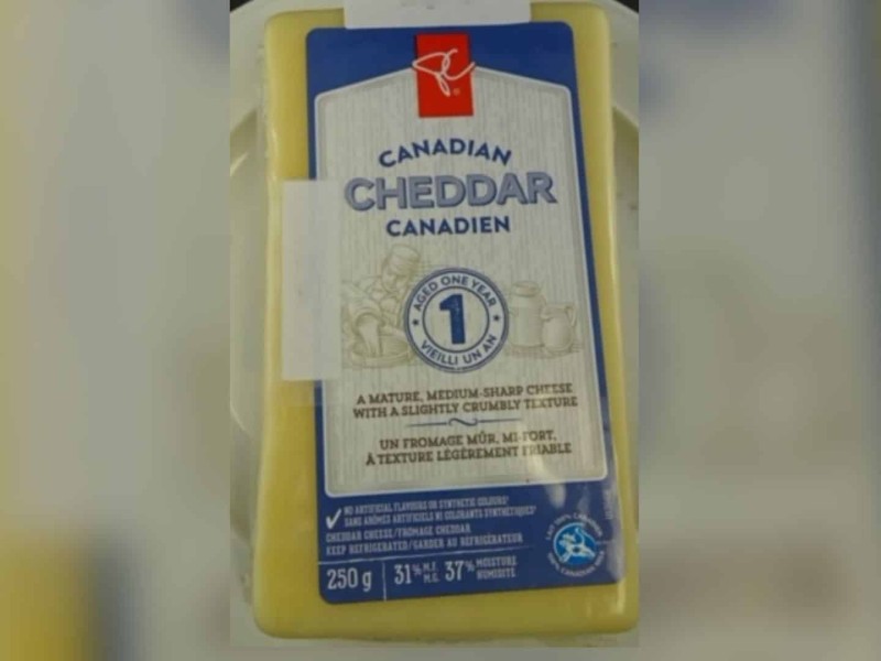 A block of off-white cheese with a blue and white label.