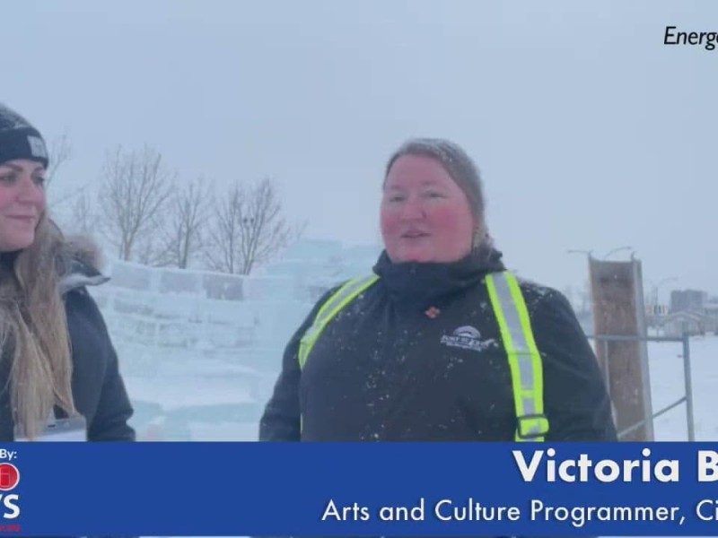 Person on left with long hair and a toque, person on right in a high viz vest