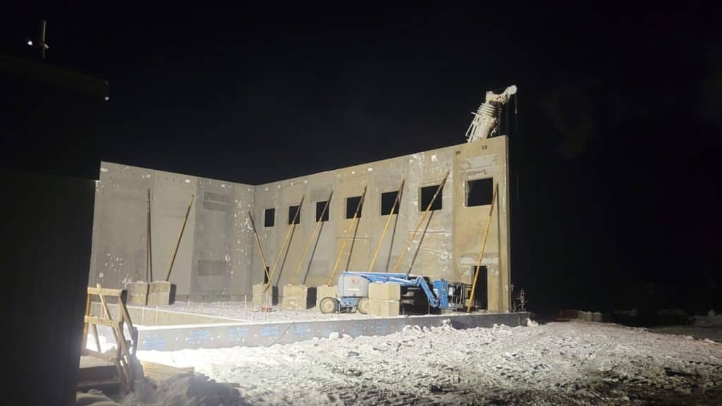 A night time photo of a construction site putting walls up