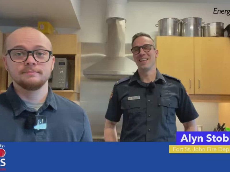 Person on left looking into the camera, person on right smiling