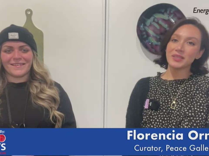 Two people standing in front of art