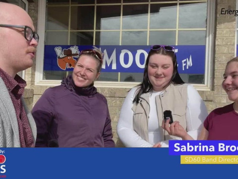 A group of people standing in front of a brick wall