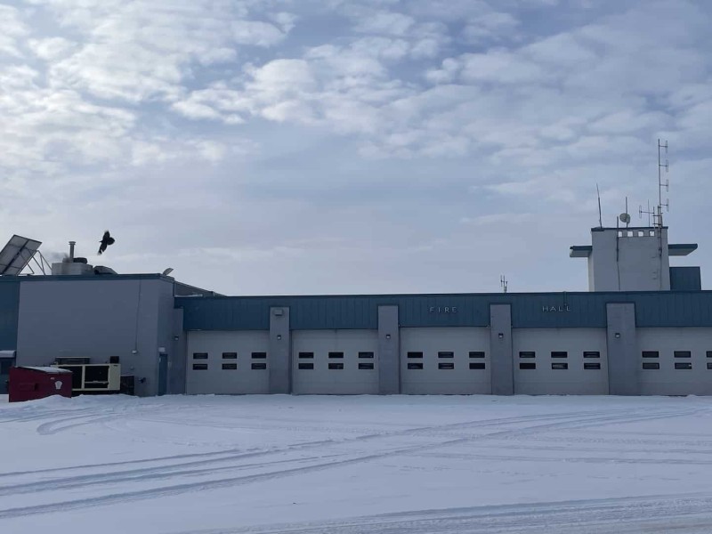A large blue building with white garage doors.