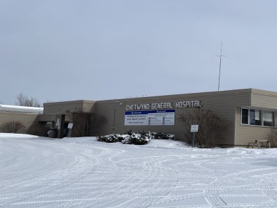 A picture of a grey building in a snowy landscape.