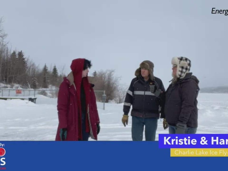 Three people in winter clothing standing on a frozen lake