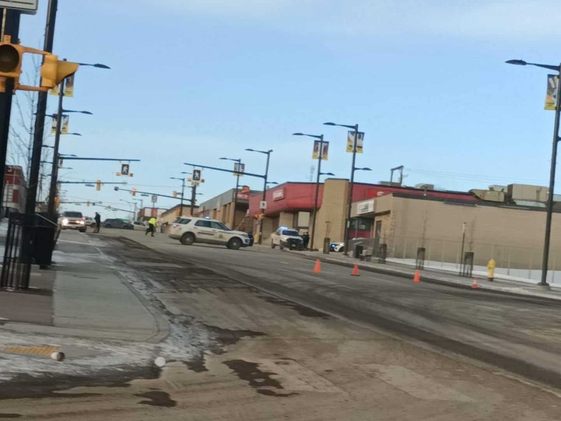 A shot of police on a road in Fort St. John with pylons blocking off most of the road.