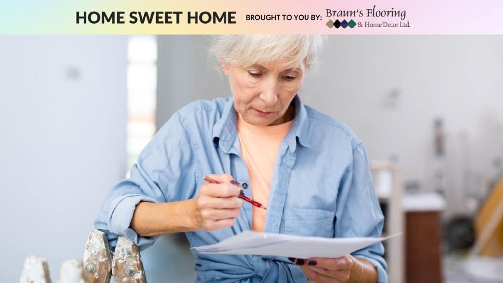 Person with white hair and a blue shirt looking at a piece of paper