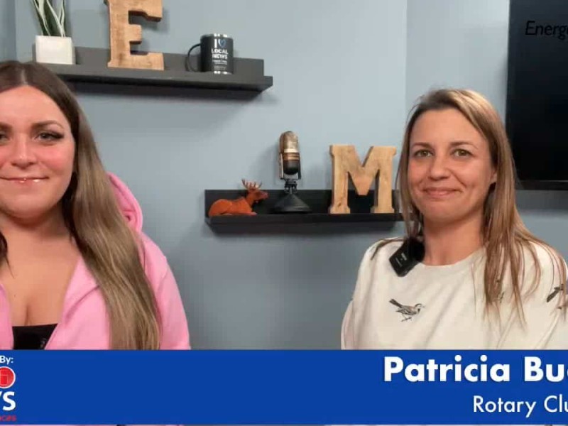 Two people smiling at the camera