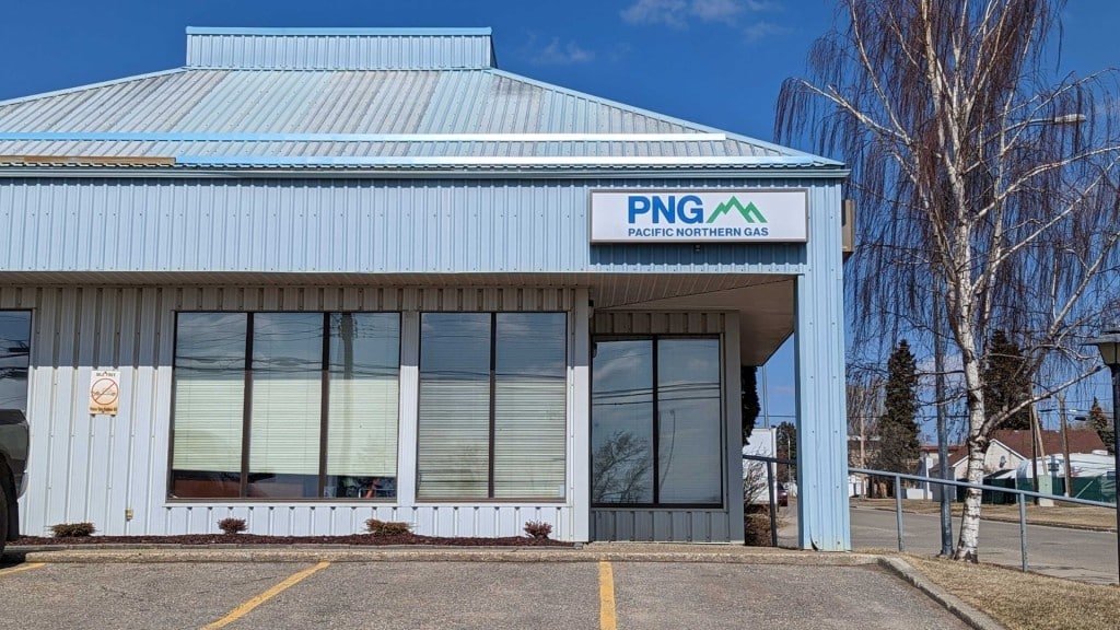 A blue building next to a tree.