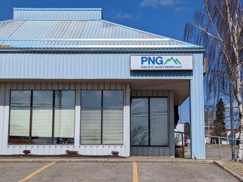 A blue building next to a tree.