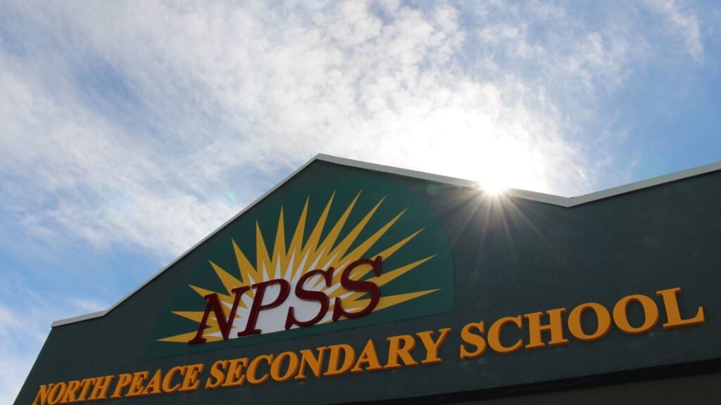 A sunny day. The entrance sign of the North Peace Secondary School.