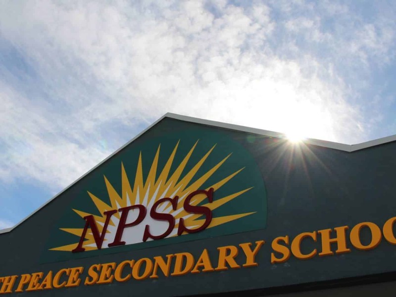 A sunny day. The entrance sign of the North Peace Secondary School.