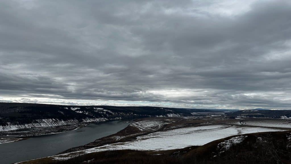A picture of the Peace Valley in snow, with the Peace river running through it.
