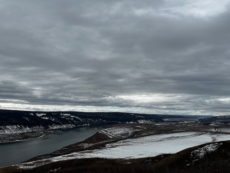 A picture of the Peace Valley in snow, with the Peace river running through it.