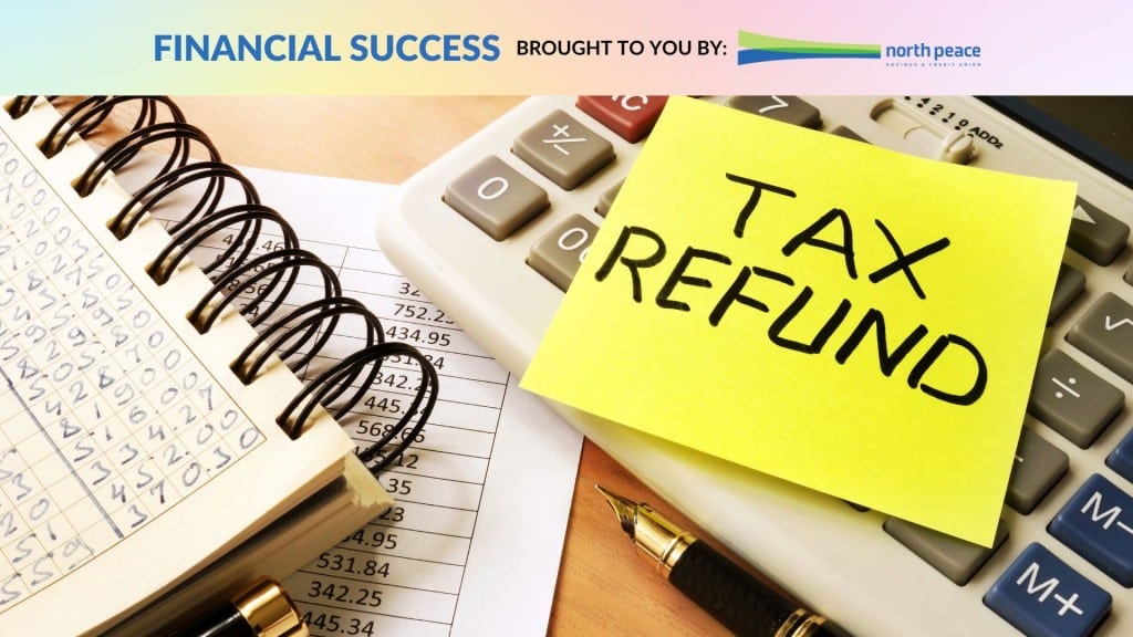 Sticky note with tax refund written on it on top of a calculator