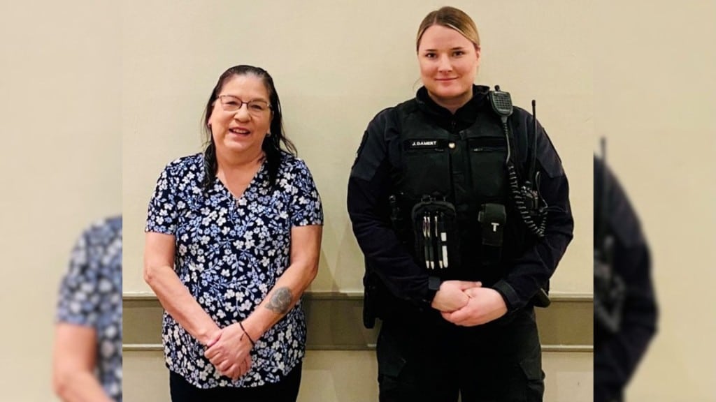 A picture of two ladies, one in a flower shirt and one in a BCCOS uniform against a plain wall.
