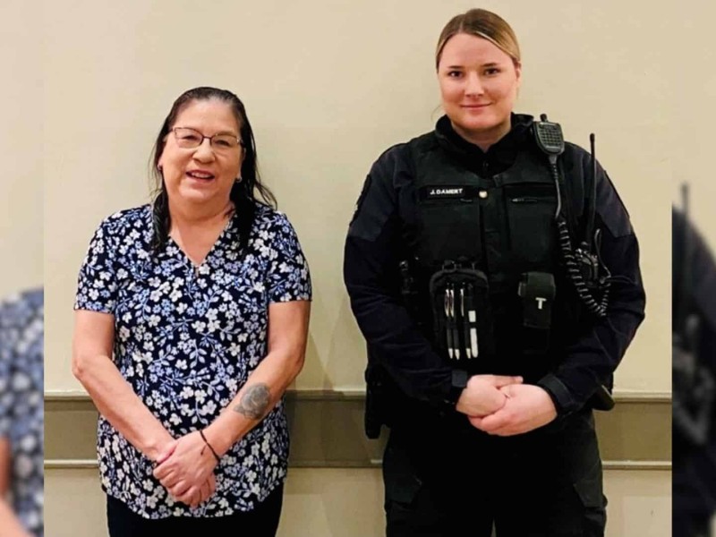 A picture of two ladies, one in a flower shirt and one in a BCCOS uniform against a plain wall.