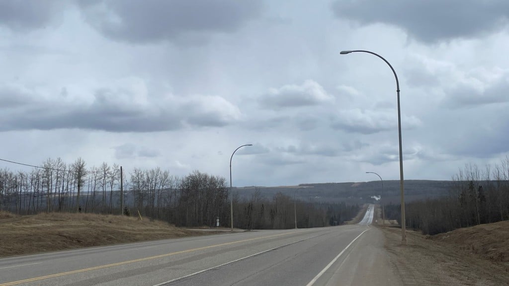 A picture of the Alaska Highway under a cloudy sky.