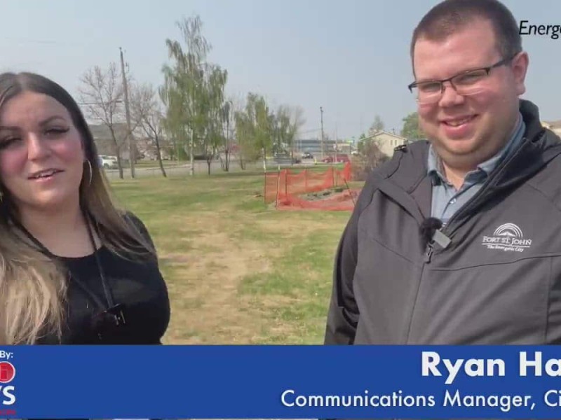 Two people in a park staring at the camera